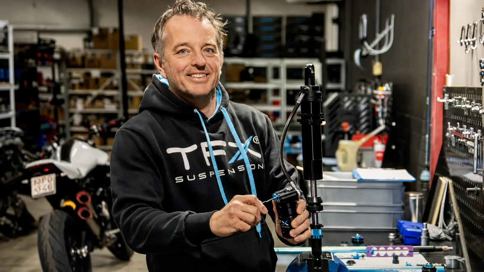 TFX suspension engineer working on a shock absorber in the TFX workshop